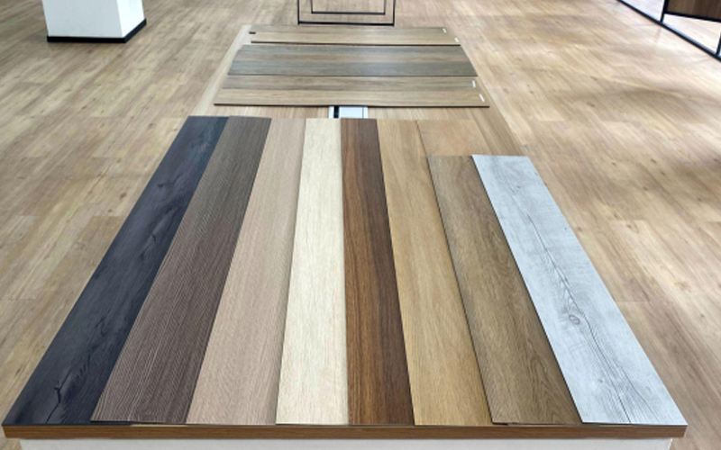  Assortment of resilient vinyl floors with wooden patterns in a showroom.