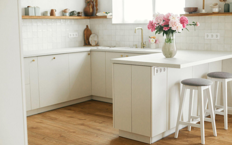 Modern minimal kitchen interior with vinyl wood flooring.
